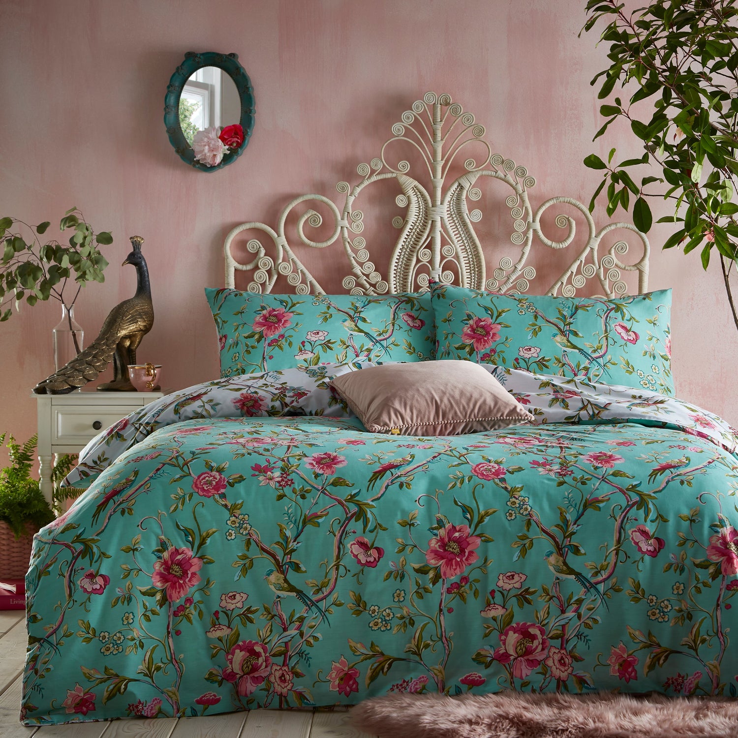 Beautiful, luxury bedding set with pink flowers and green leaves in a vintage style and jade background