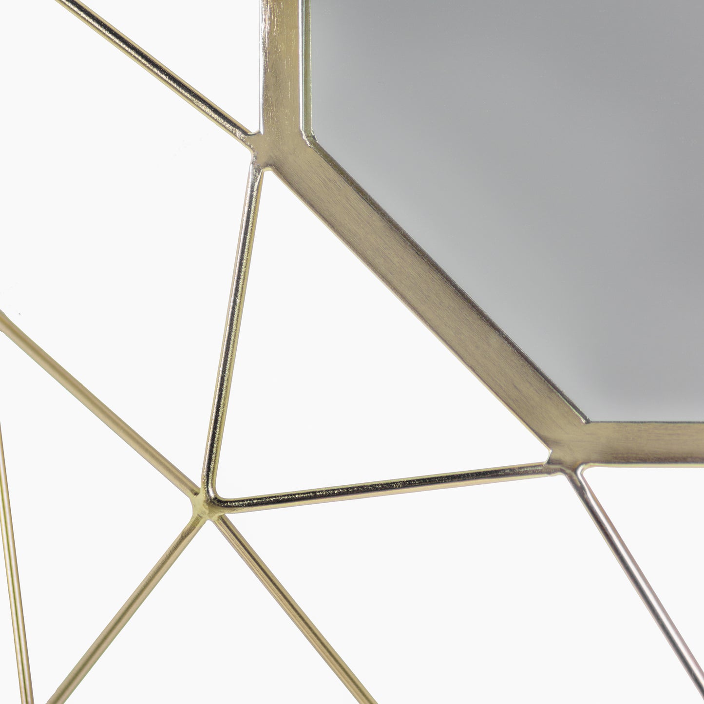 Close up of edge of gold geometric brass mirror