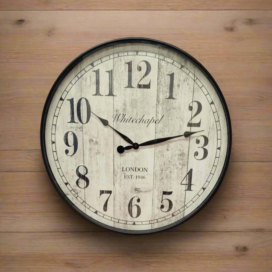 Antique round wall clock with a light, natural rustic wood wallpaper background with subtle wood grain showing