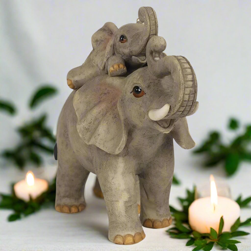 mother and baby elephant playing, candle and foliage