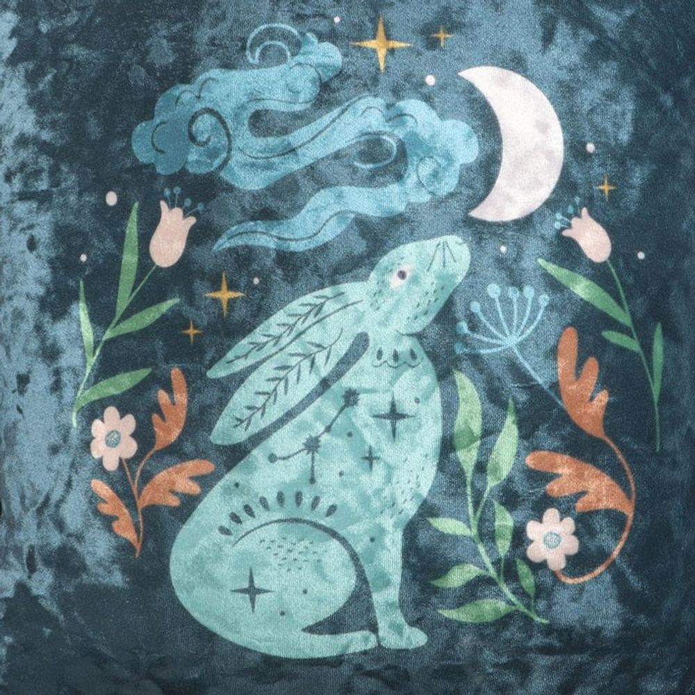 Close up of square cushion with a velvety midnight blue scene with a hare staring up at the moon - base on the story 'love you to the moon and back'